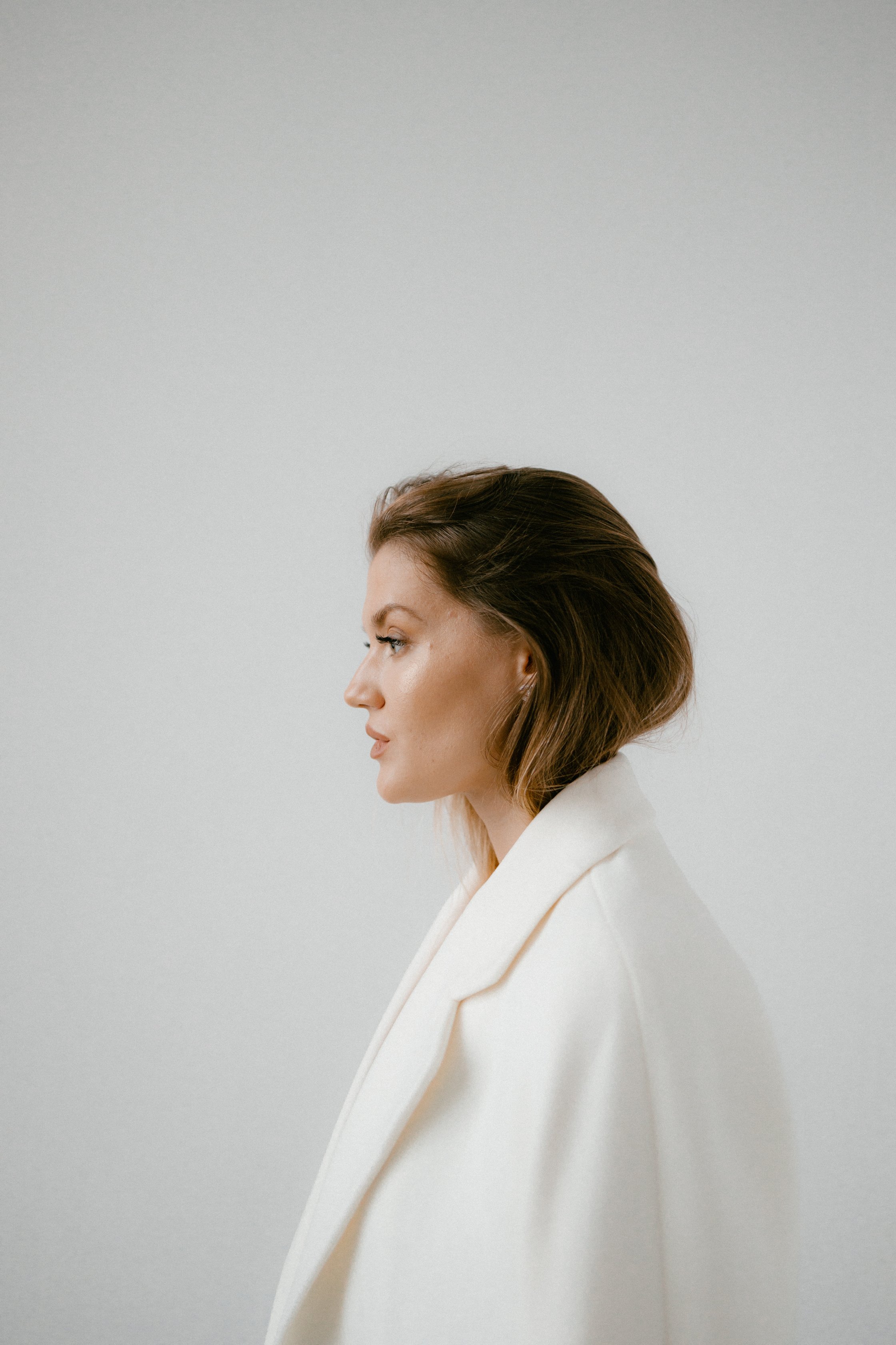 Side View of a Woman Wearing White Coat